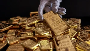 An employee handles one kilogram gold bullions at the YLG Bullion International Co. headquarters in Bangkok, Thailand, Dec. 22, 2023.