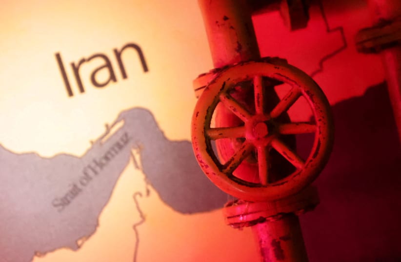  A map showing the Strait of Hormuz and Iran is seen behind a 3D printed oil pipeline in this illustration taken June 22, 2025 (photo credit: REUTERS/DADO RUVIC)
